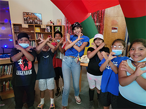 Teacher and students making hand signs