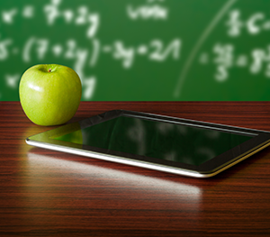 apple and tablet on a desk 
