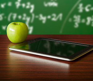 apple with tablet at desk